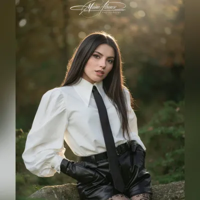 Nature as a studio. Soft light filtering through the trees, a wooden log as a seat, and an outfit that speaks of contra…