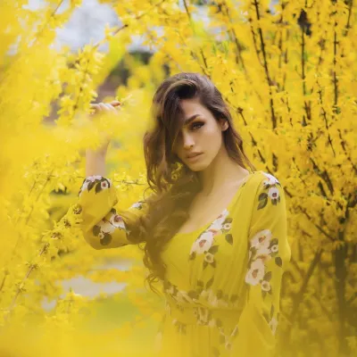 Yellow on yellow. A figure steps into the bloom, dressed in the language of the season.