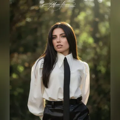Where elegance meets the wild. A white shirt, a black tie, and the quiet language of natural light — this is fashion st…